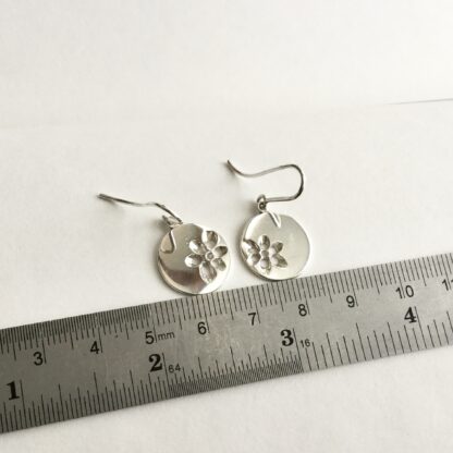 Sterling silver pierced floral disk drop earrings