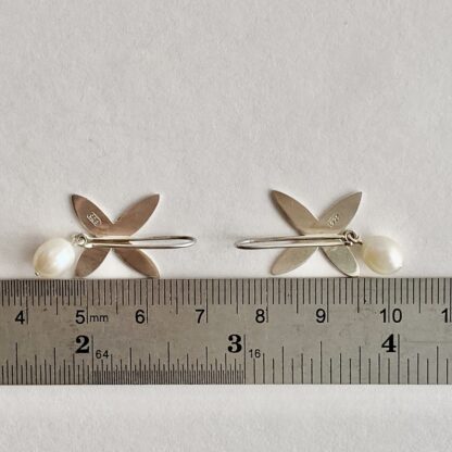 Flower shaped sterling silver drop earrings with freshwater pearl drops