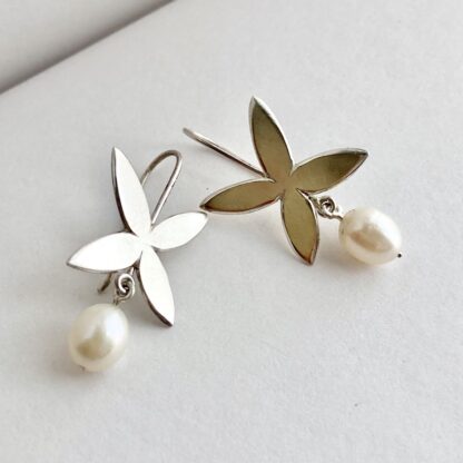 Flower shaped sterling silver drop earrings with freshwater pearl drops