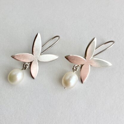 Flower shaped sterling silver drop earrings with freshwater pearl drops