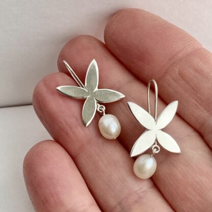Flower shaped sterling silver drop earrings with freshwater pearl drops
