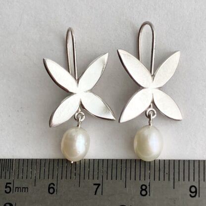 Flower shaped sterling silver drop earrings with freshwater pearl drops
